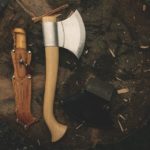 Knife axe and other tools on the wood bark