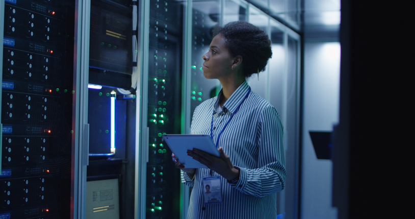 Smiling ethnic woman in data center